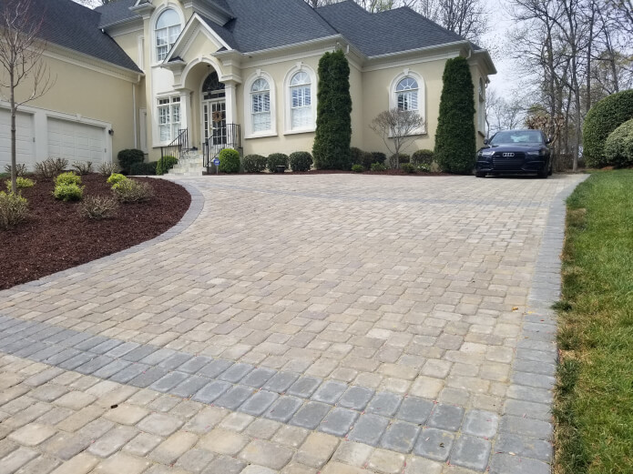 A perfectly maintained and well-kept stone driveway in the front of a house.
