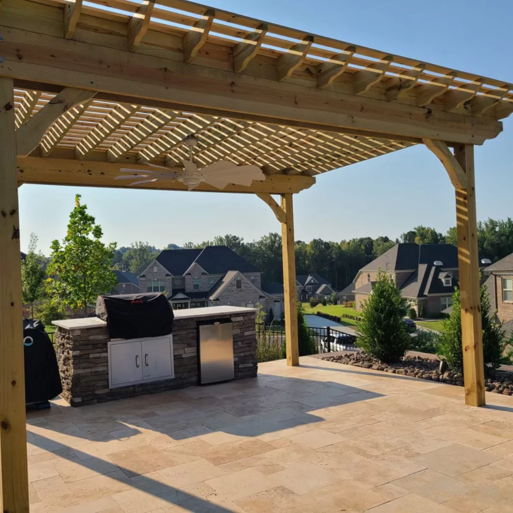 A beautiful wooden pergola covering an outdoor kitchen
