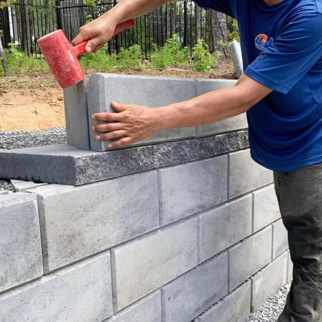 Sunsouth Carolinas crews building a wall in a backyard.