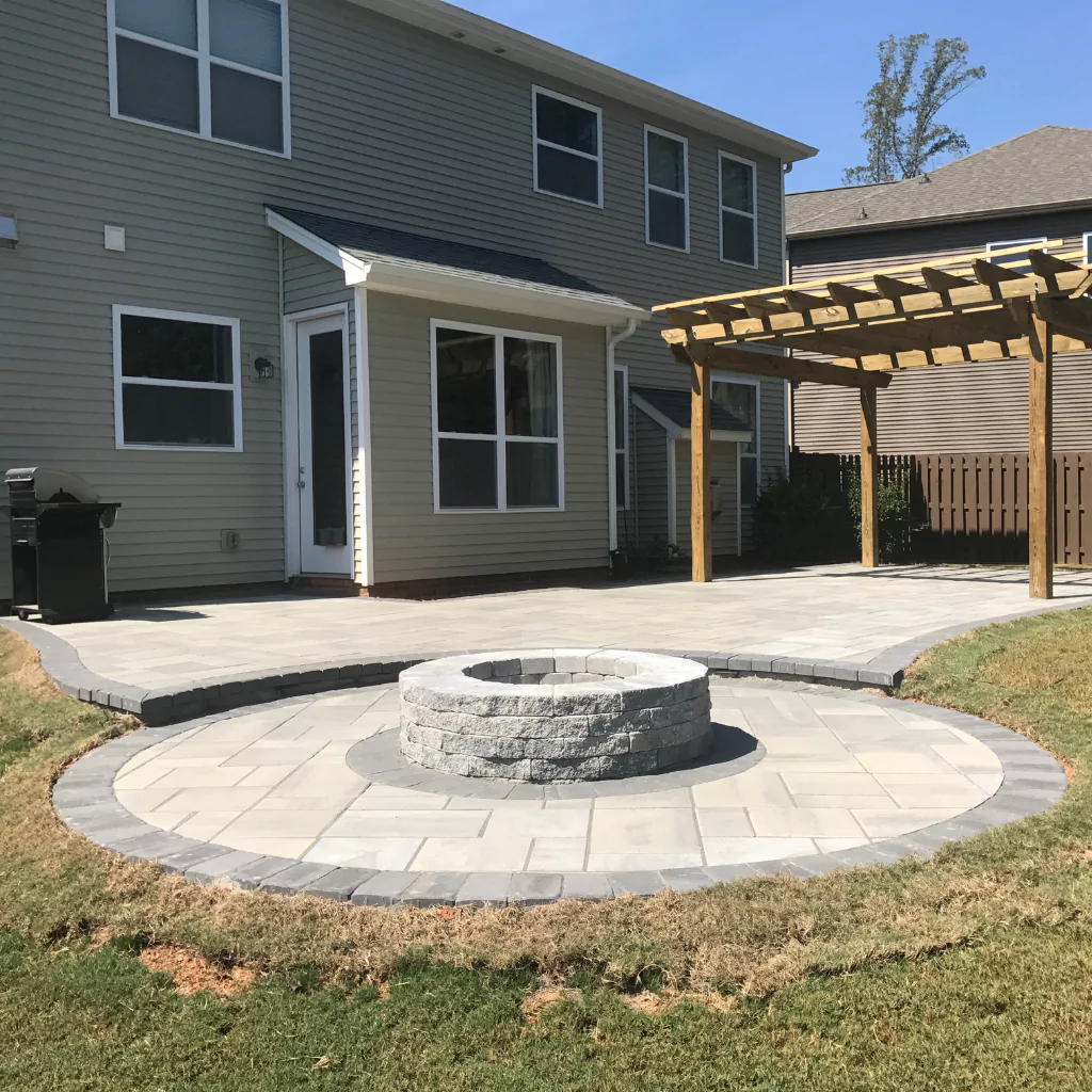 A Fire Pit with a pergola nearby. There's an elegant stone flooring
