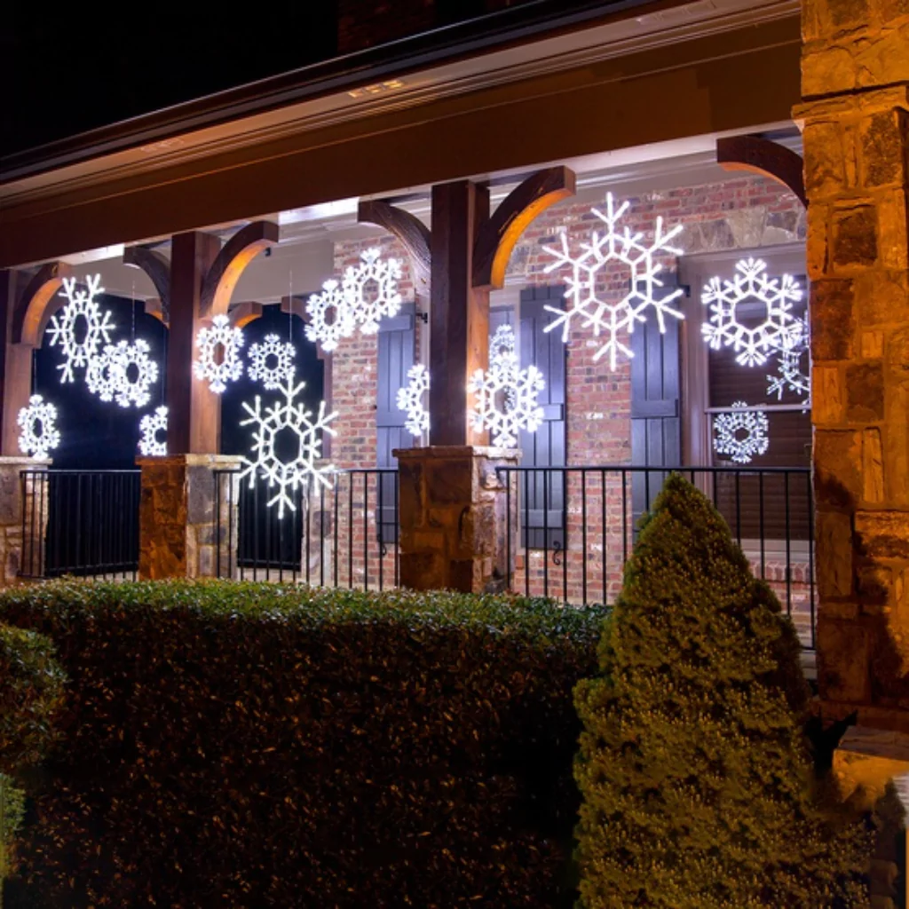 A LED snowflake decoration that it hanging from a pergola.