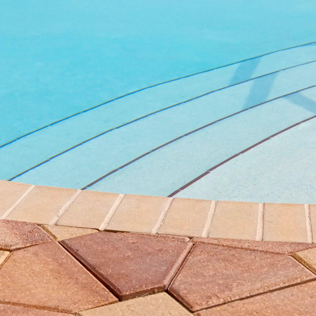 A pool with pavers around it