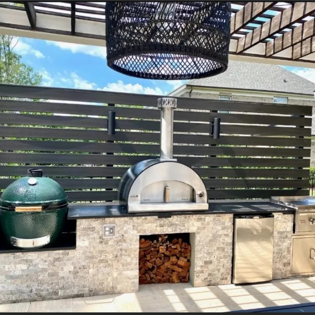 An outdoor kitchen with a grill