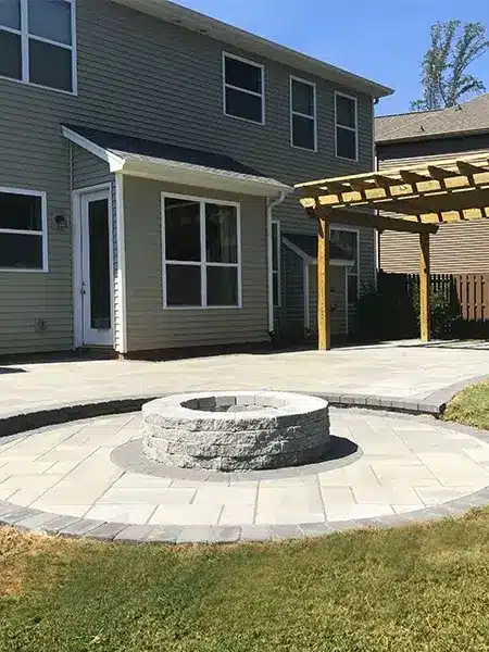 A spectacular stone fire pit built in a backyard