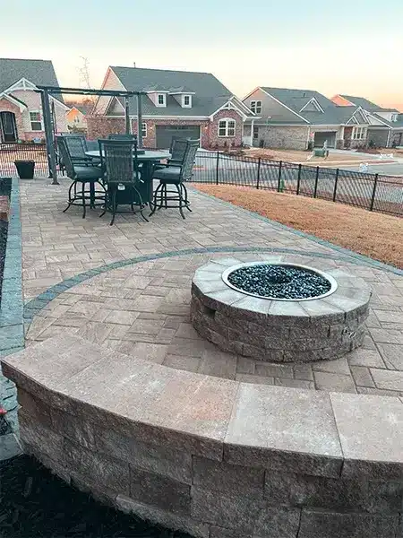 A beautiful stone fire pit along with a sitting wall. The perfect combination to create beautiful memories in your backyard.
