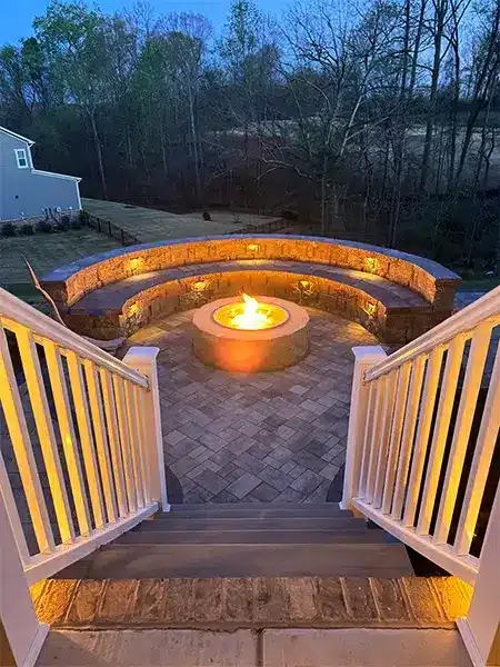 A beautiful patio with a stone fire pit that gives warmth, comfort and a beautiful view.