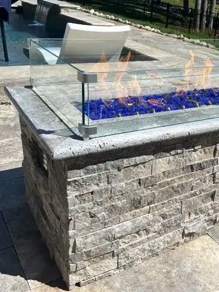 A beautiful patio with a stone fire pit that gives warmth, comfort and a beautiful view.