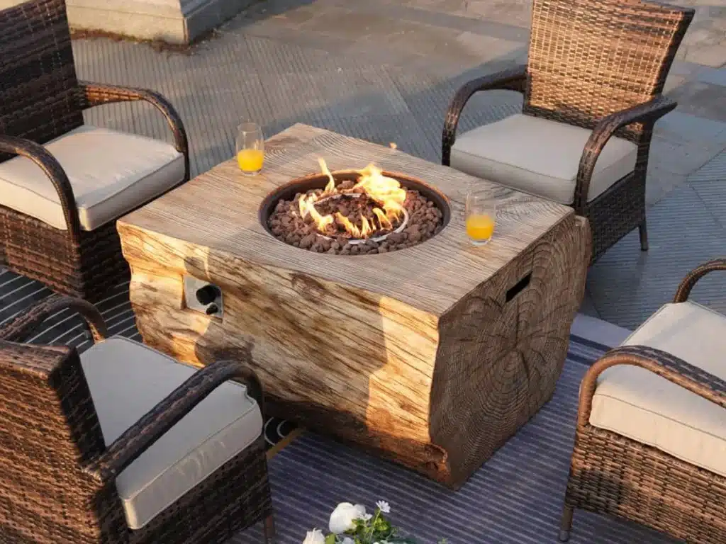 A fire pit built in wood with some chairs around it