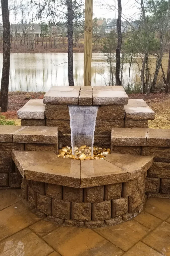 A beautiful stone outdoor fountains built in a patio.