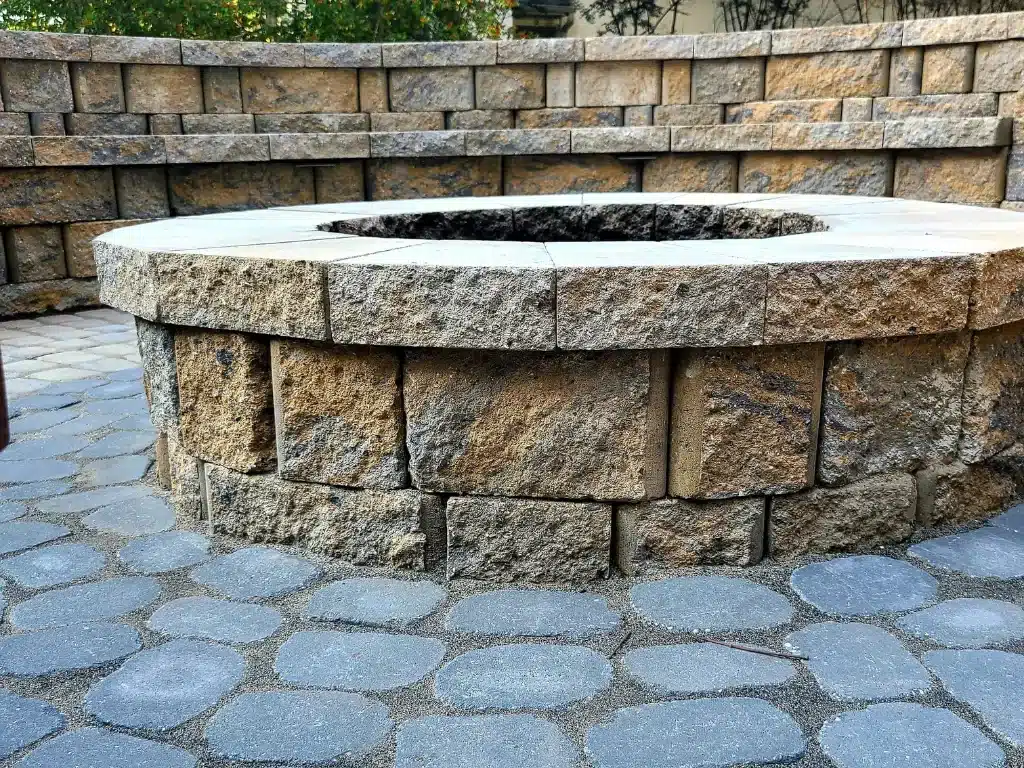 A robust fire pit built in stone, using one of the best materials for outdoors.
