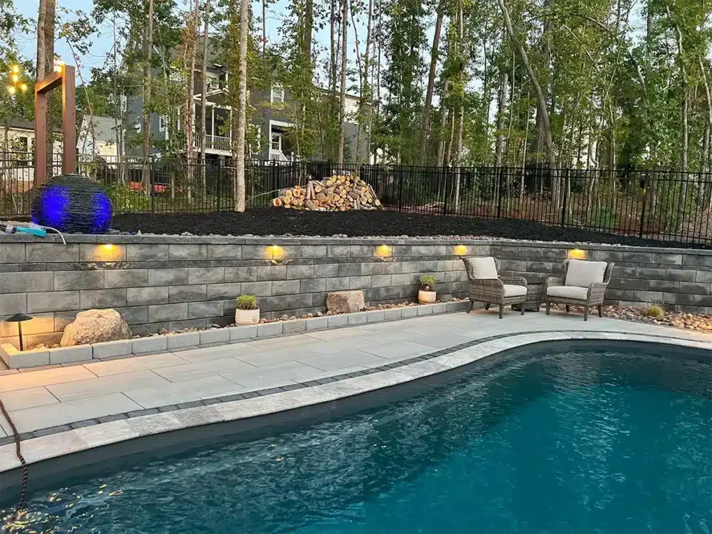 SunSouth Carolinas enhances poolside safety and ambiance with expertly installed hardscape lighting within retaining walls and steps.