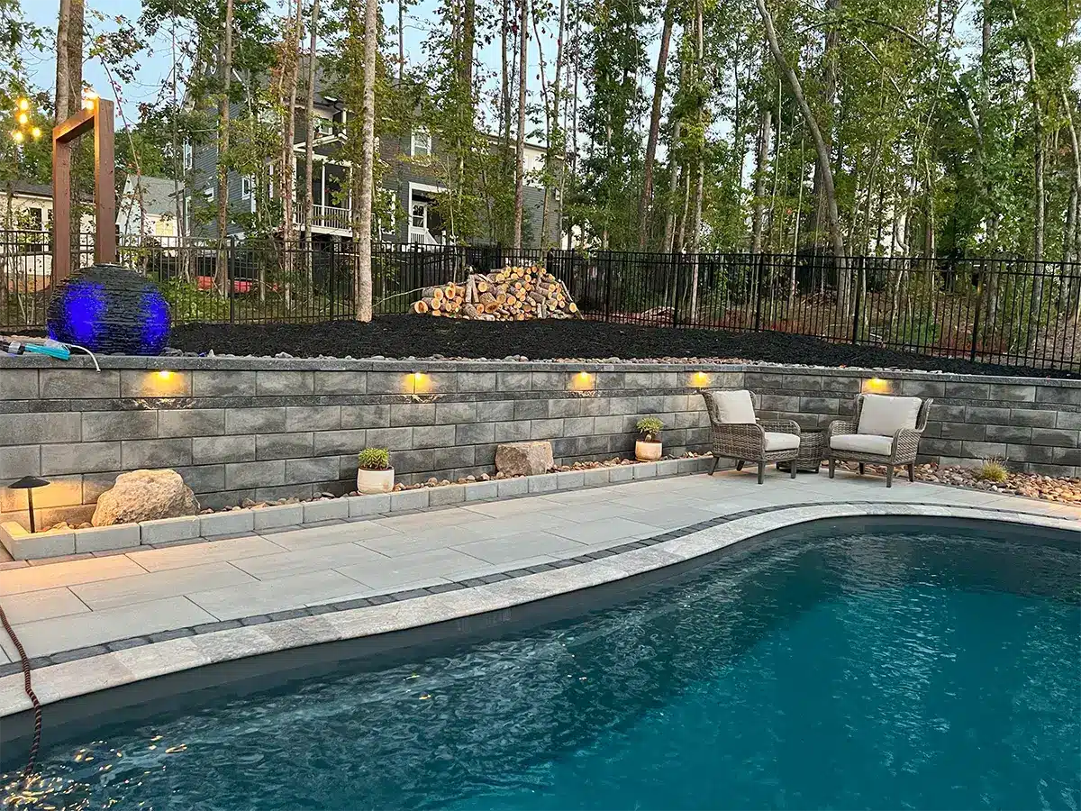 SunSouth Carolinas enhances poolside safety and ambiance with expertly installed hardscape lighting within retaining walls and steps.