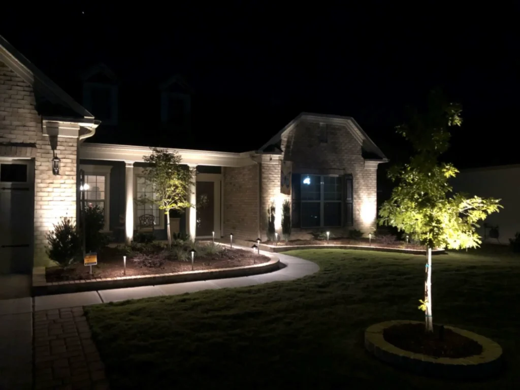 SunSouth Carolinas expertly lights a curving front walkway and landscape beds using path lights, while uplighting highlights trees and architectural columns.