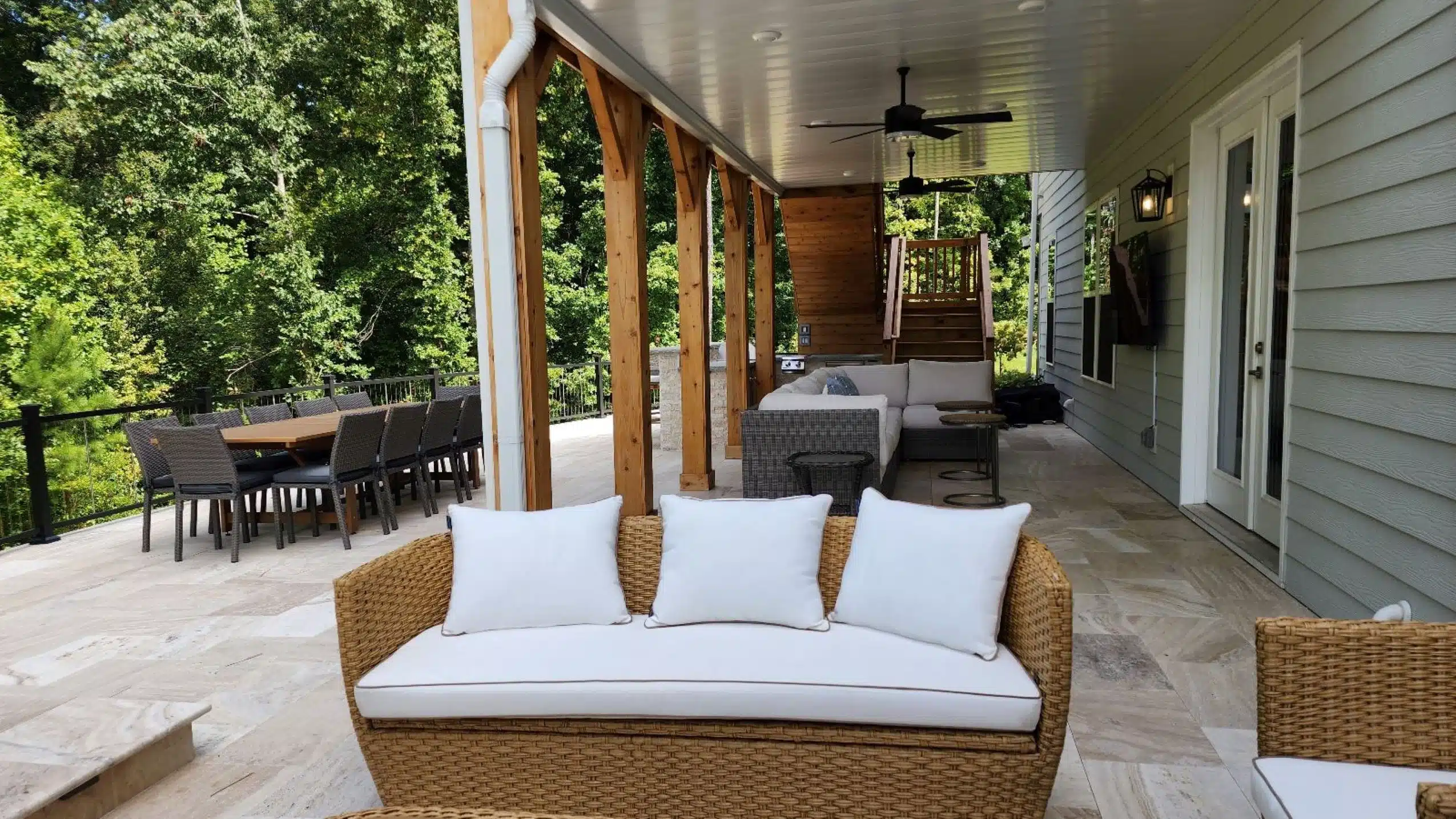 SunSouth Carolinas creates covered outdoor living spaces: impressive pavilion structure with wood pillars, masonry accents, hardscaping floor, custom outdoor lighting, and integrated custom outdoor kitchen.