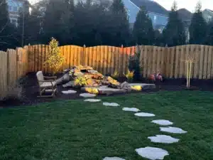 Close-up view of a custom rock water feature with integrated landscape lighting, installed by SunSouth Carolinas to create a peaceful backyard retreat