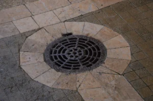 Effective paver patio proper drainage system with a sturdy grate, essential for preventing water pooling and protecting your hardscape investment. Installed by SunSouth Carolinas