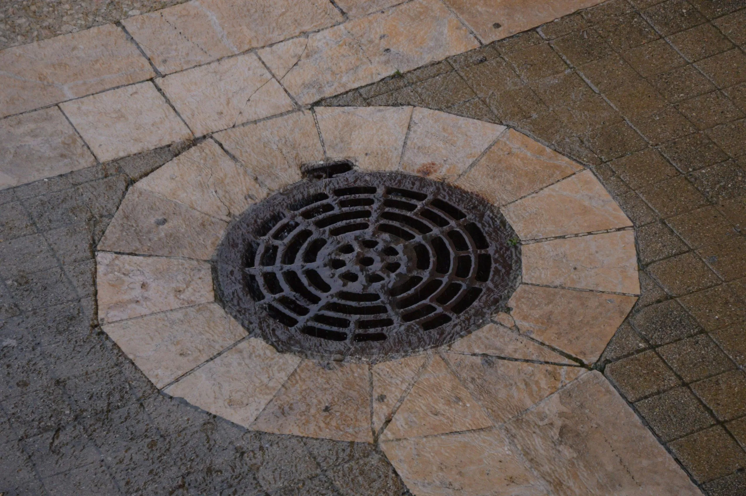 Effective paver patio proper drainage system with a sturdy grate, essential for preventing water pooling and protecting your hardscape investment. Installed by SunSouth Carolinas