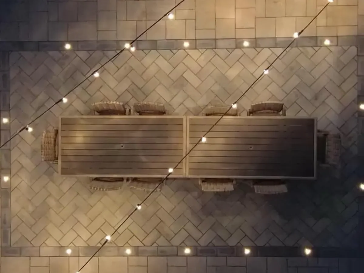 Complete backyard transformation by SunSouth Carolinas featuring multiple zones including paver patio, full outdoor kitchen installation, pergola, and integrated lighting.