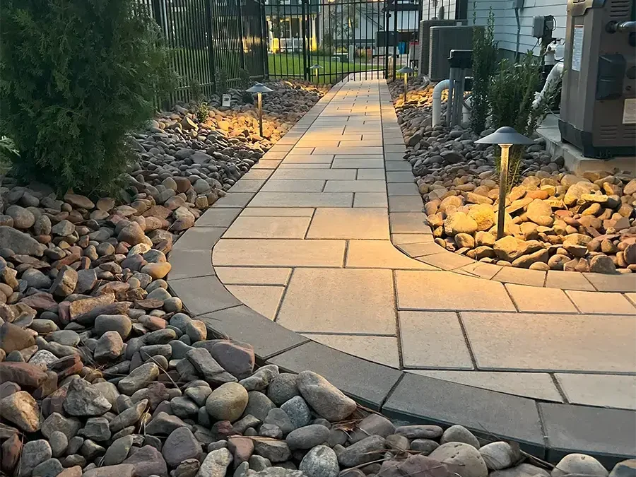 SunSouth Carolinas installs contemporary walkways combining pavers and decorative rock with integrated, low-profile path lighting.