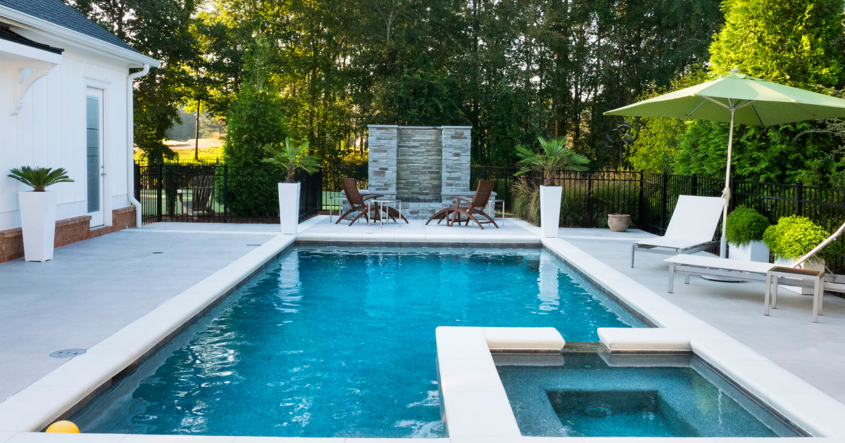 Modern pool with lounge chairs and greenery
