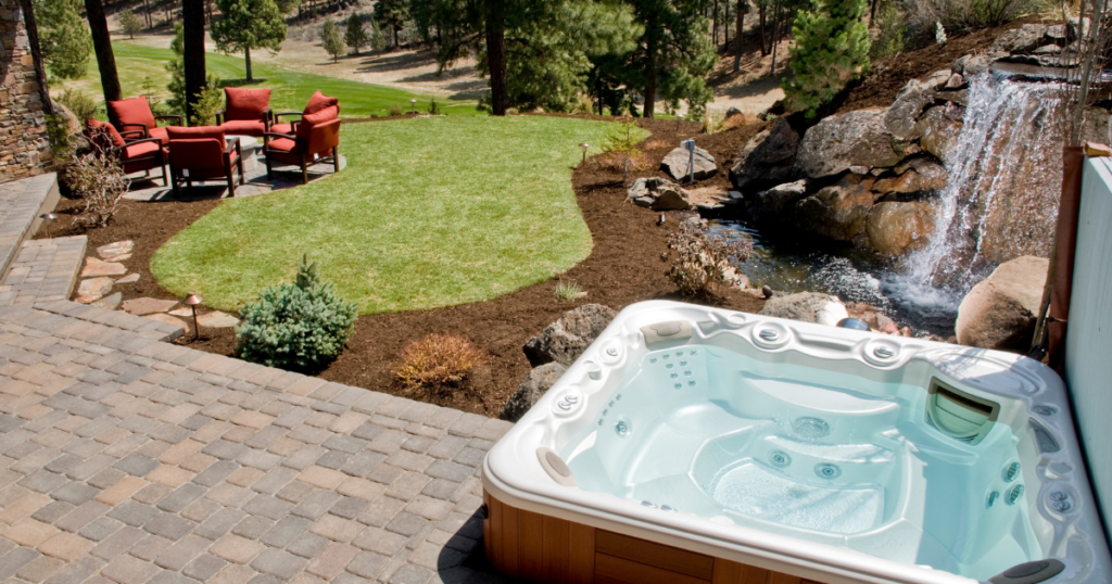 Hot Tubs 12 Hot tub near landscaped backyard waterfall
